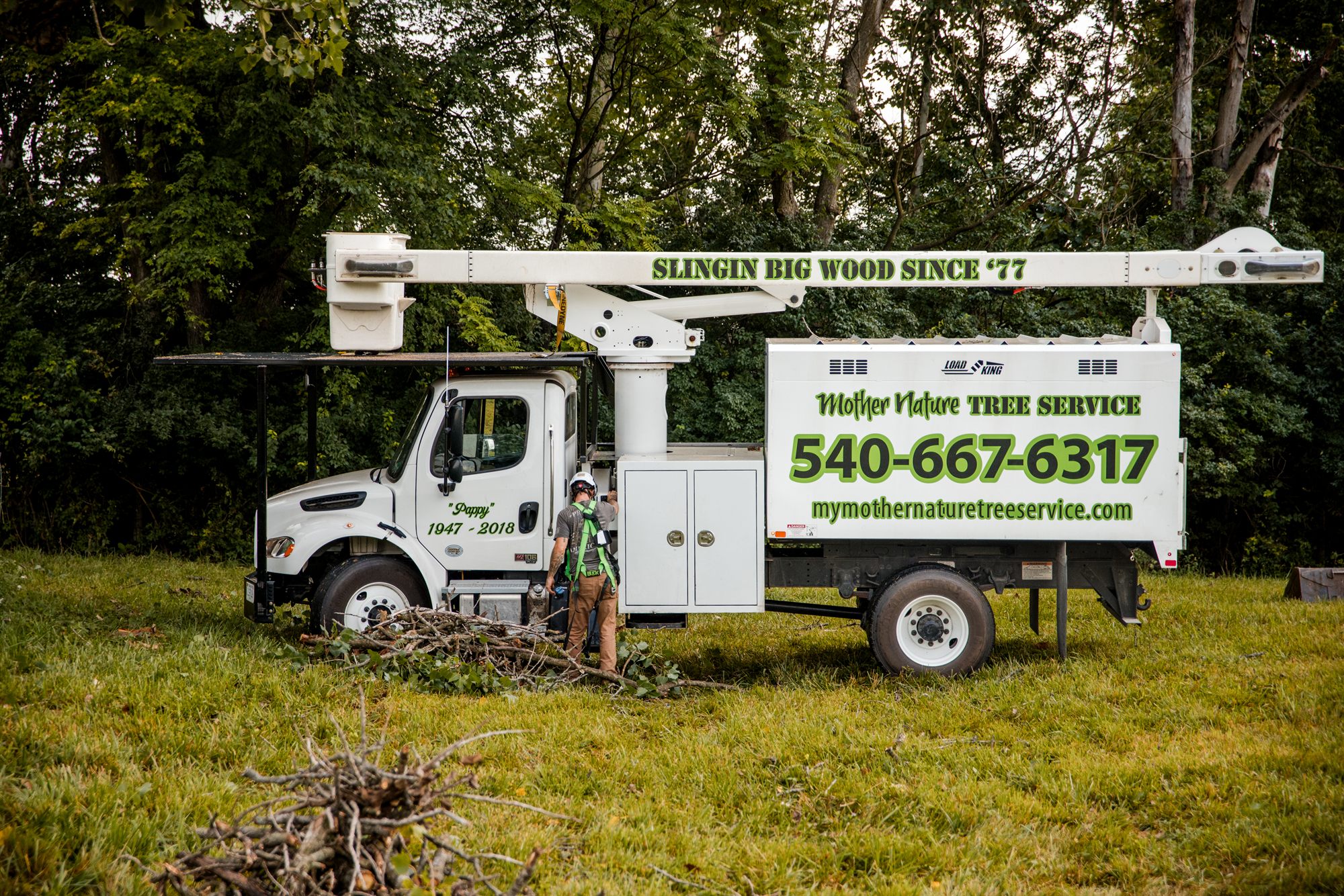 Truck loaded beside brush piles on a Winchester, VA tree job