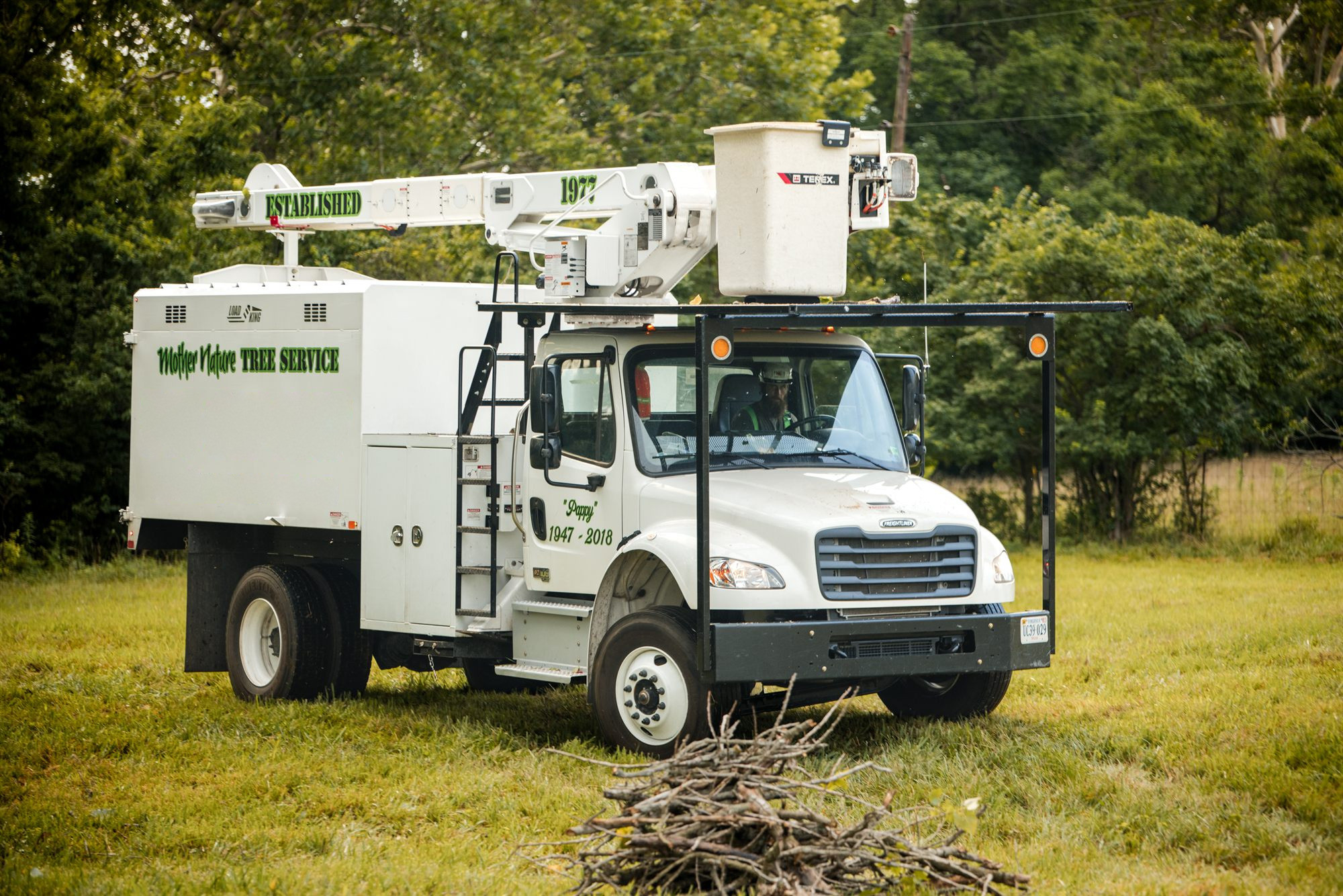 A bucket truck photographed from the front three quarter angle at a job site in Berryville, VA