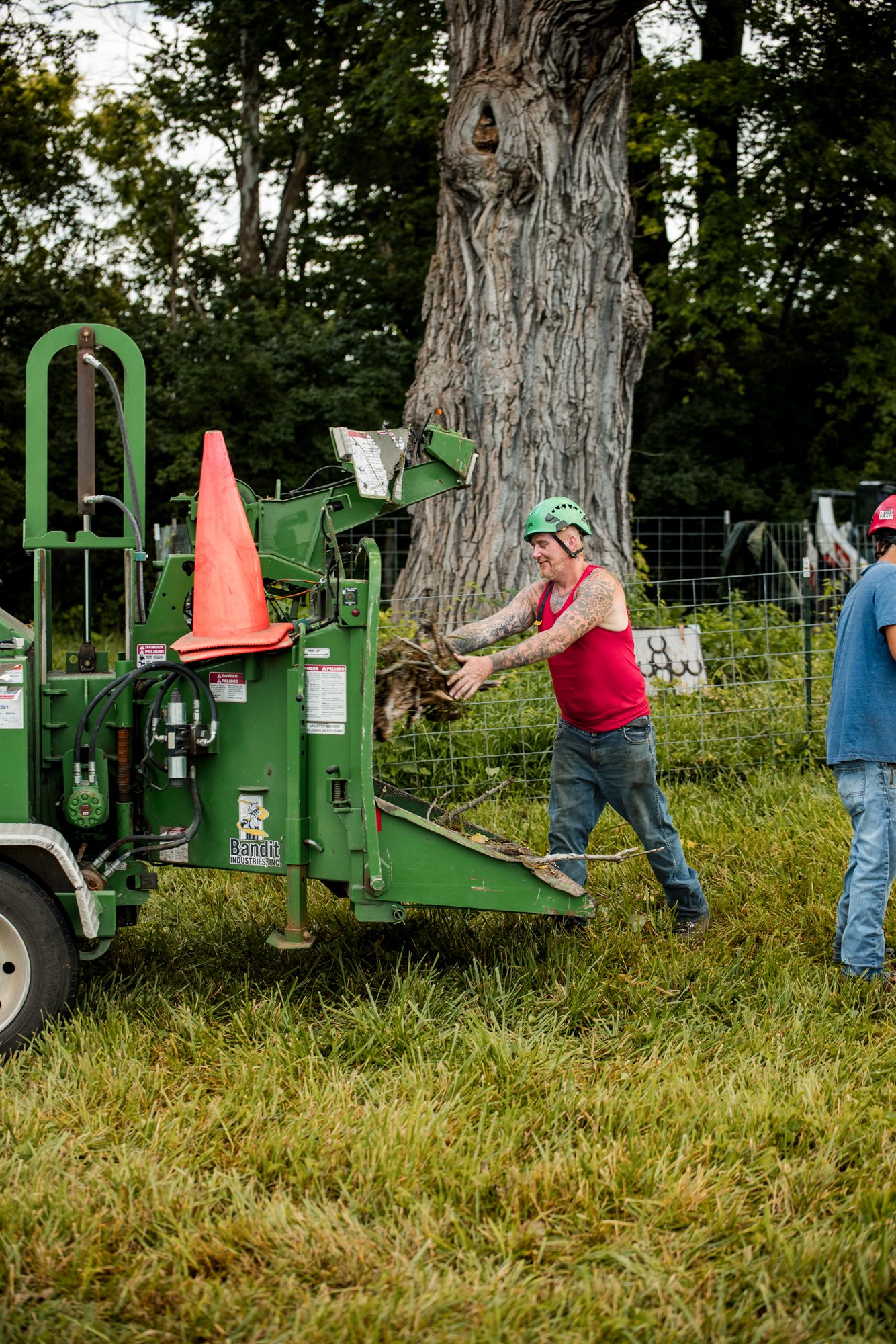 Crew member feeding brush into the chipper
